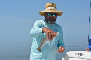 fisherman holding speckled trout