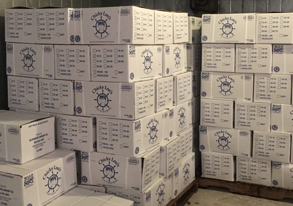 multiple boxes of Chicky Lou shrimp boxes stacked