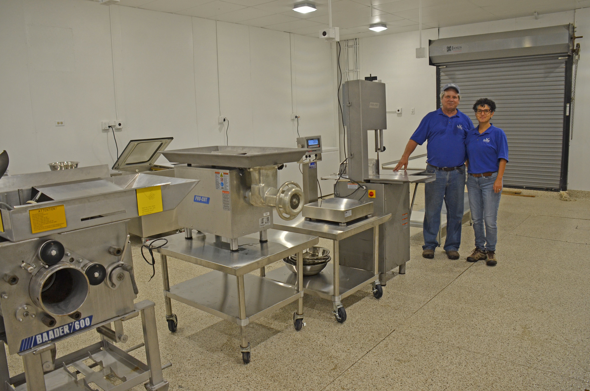 Dr. Evelyn Watts and Thomas Hymel, directors, standing next to equipment in the Seafood Processing Demonstration Lab