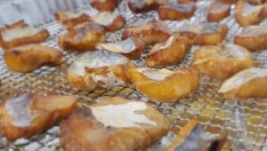 smoked fish bites on a metal rack.